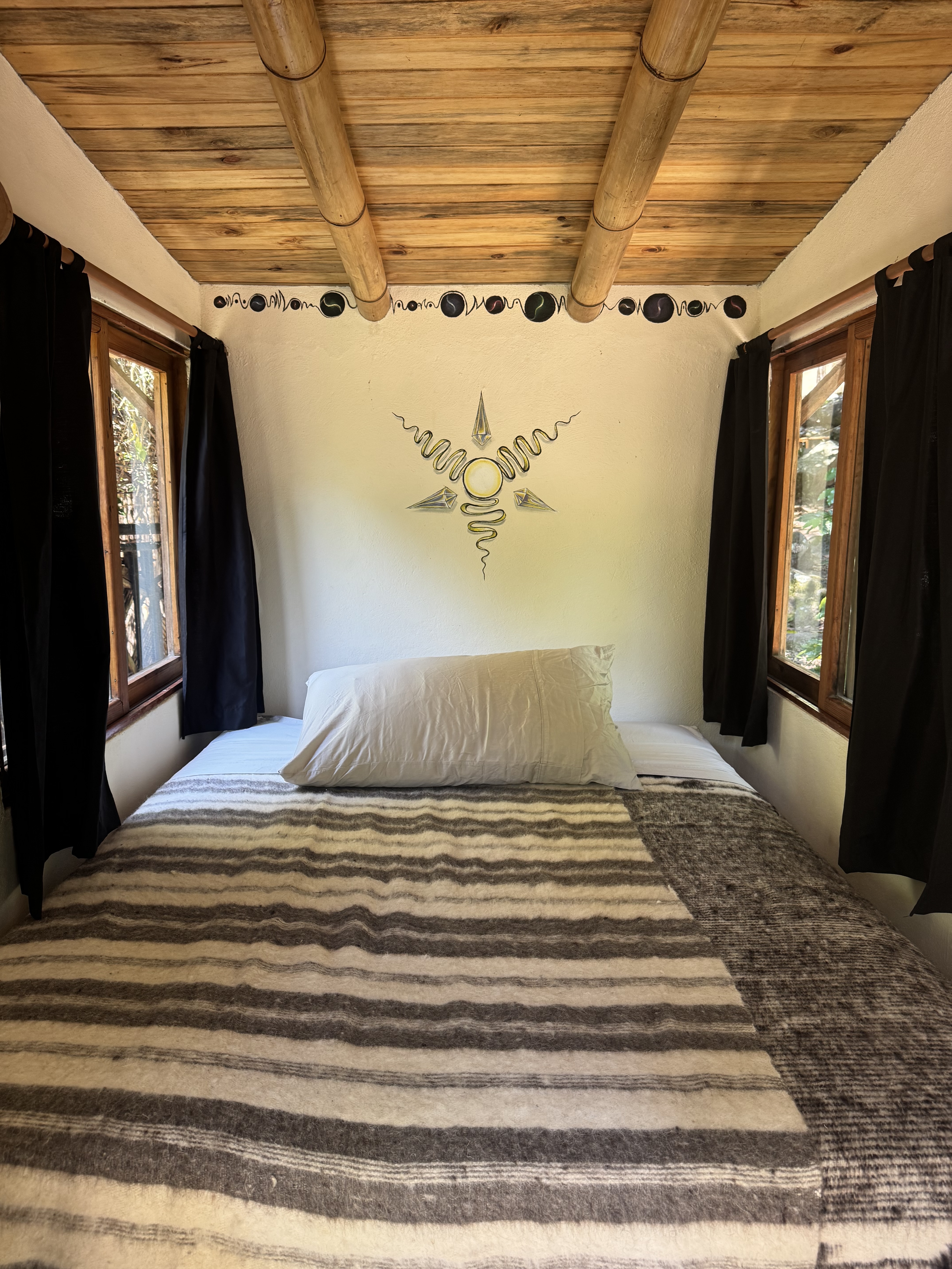 Wooden double bed cabin — dark roof, skylight