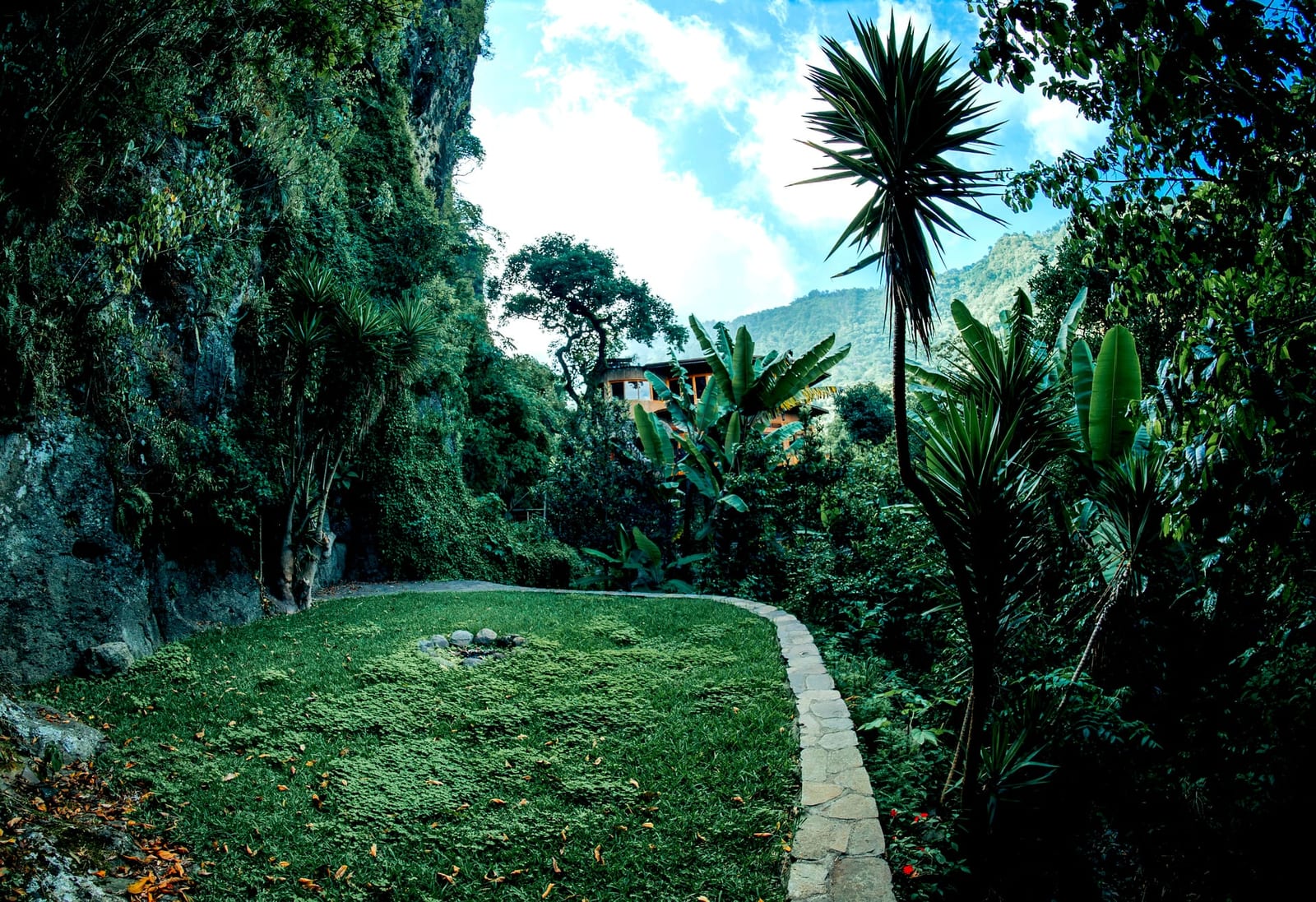 Garden path winding through the grounds toward the mountains